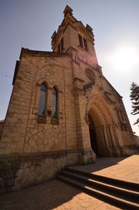 Low angle view of bell tower against sky