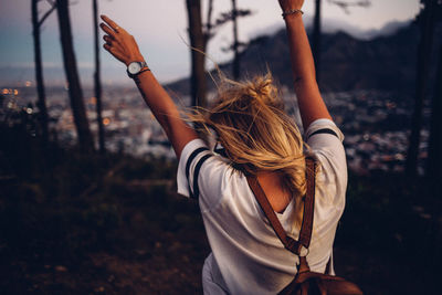 Rear view of woman standing in forest