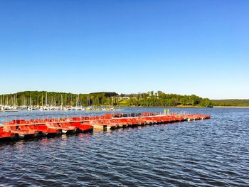 Scenic view of lake against clear blue sky