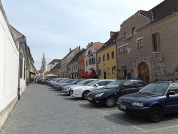 Cars parked on road in city