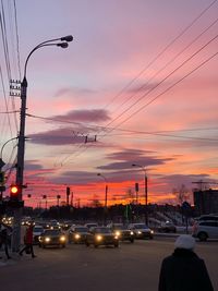 Traffic on road at sunset