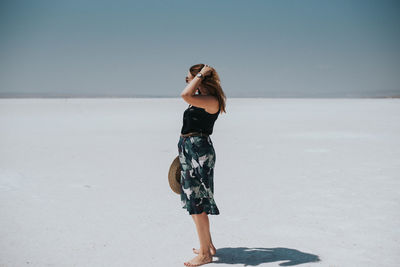 Full length of woman standing against sky