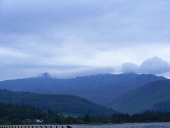 Scenic view of mountains against storm clouds