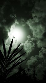 Low angle view of silhouette tree against storm clouds