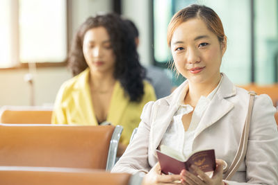 Young woman using digital tablet while sitting at home