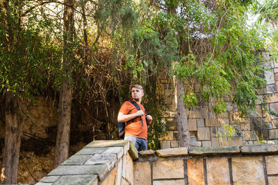 Full length of man standing by tree in forest