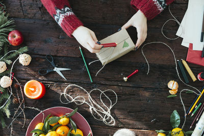 High angle view of hand holding fruits on table