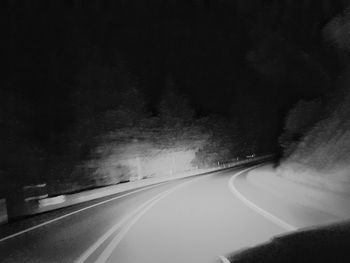 Empty road along trees