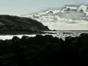 Scenic view of sea against cloudy sky