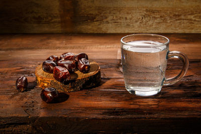 Food for iftar in ramadan on a wooden table dates and water. horizontal photo