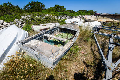 High angle view of abandoned fishing boats on field