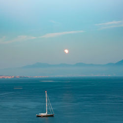 Sailboat sailing on sea against sky