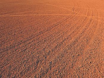 Dry light red crushed bricks surface on outdoor tennis playground court