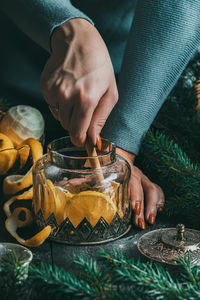 Autumn or winter hot tea with lemon and sugar with steam above the cup on a dark background