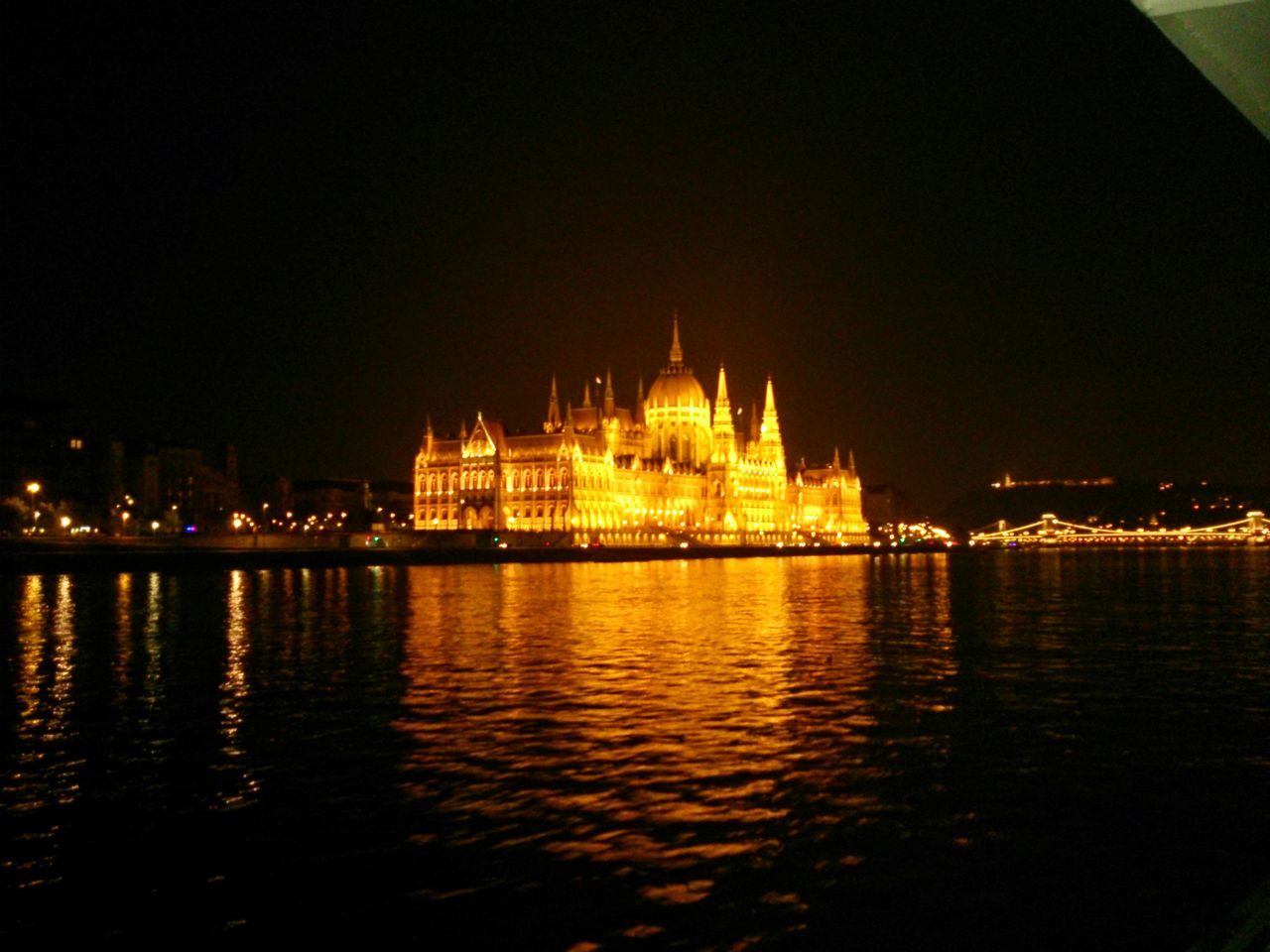 VIEW OF ILLUMINATED CITY AT NIGHT