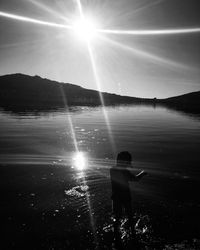 Rear view of silhouette person against bright sun