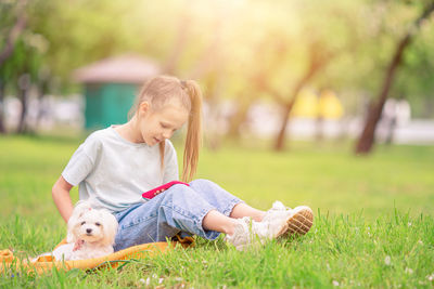 Rear view of woman with dog on field