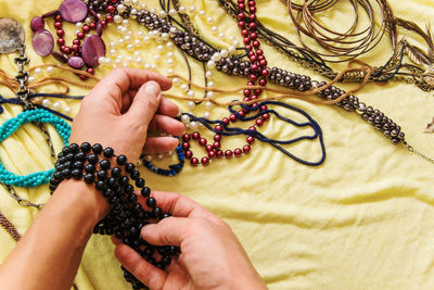 Cropped hands of woman wearing bracelet indoors