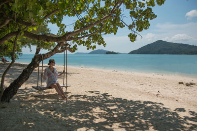 Woman swinging at beach