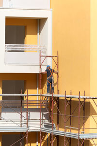 Man working at construction site against building