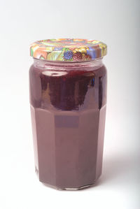 Close-up of glass of jar against white background