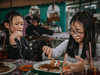 Young woman having food at restaurant