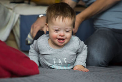 Close-up of boy sitting on table