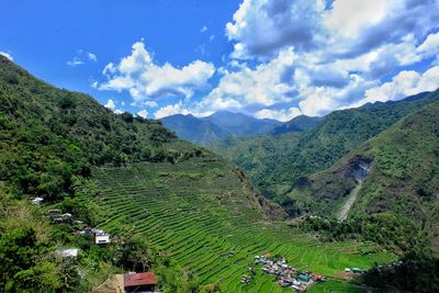 Scenic view of mountains against cloudy sky