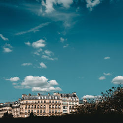 Low angle view of buildings against blue sky