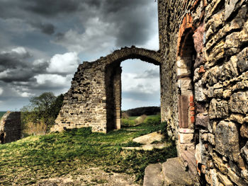 Old ruins of building against cloudy sky