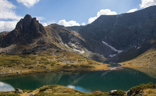 Scenic view of lake and mountains against sky