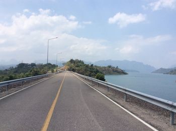 Road by mountain against sky