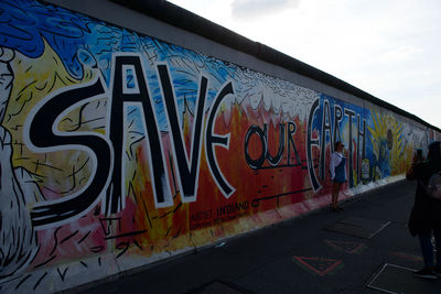 Graffiti on wall against sky