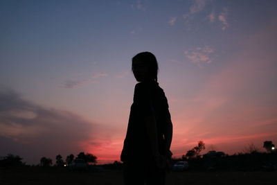 Silhouette people standing against sky during sunset
