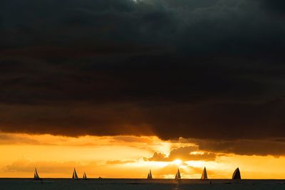 Scenic view of dramatic sky over sea during sunset