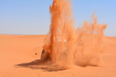 Off road vehicle driving through desert