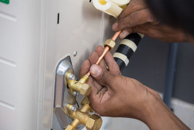 Cropped hands of repairman working at home