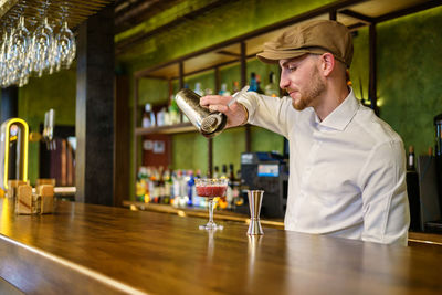 Portrait of young man drinking water