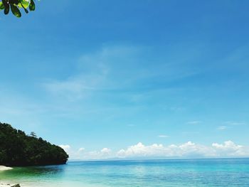 Scenic view of sea against blue sky