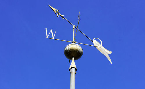 Low angle view of street light against blue sky