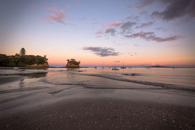 Scenic view of beach against sky during sunset