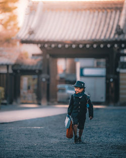 Full length of boy wearing sunglasses standing outdoors