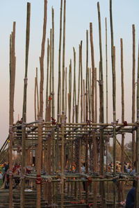Low angle view of wooden post against sky
