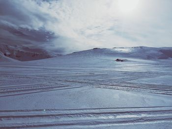 Scenic view of snow covered mountains against sky