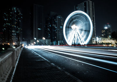View of illuminated ferris wheel at night