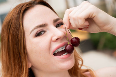 Close-up of woman eating cherries