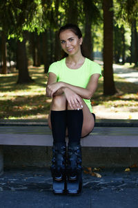 Portrait of a smiling young woman sitting outdoors