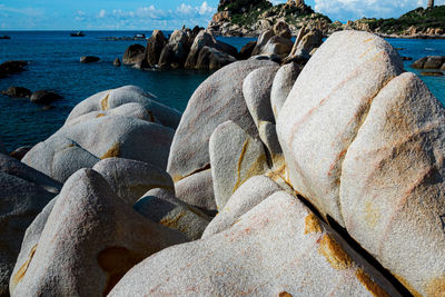 Rock formation on beach against sky