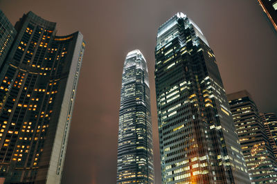 Low angle view of illuminated buildings against sky at night