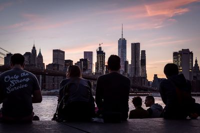 Rear view of people looking at cityscape